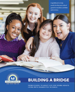 Three girls and a teacher smile at the camera while reading books in front of them